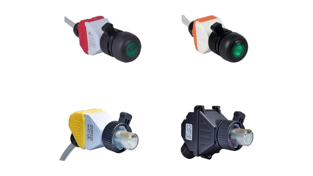 Four panel-mount illuminated industrial control modules photographed on a white background